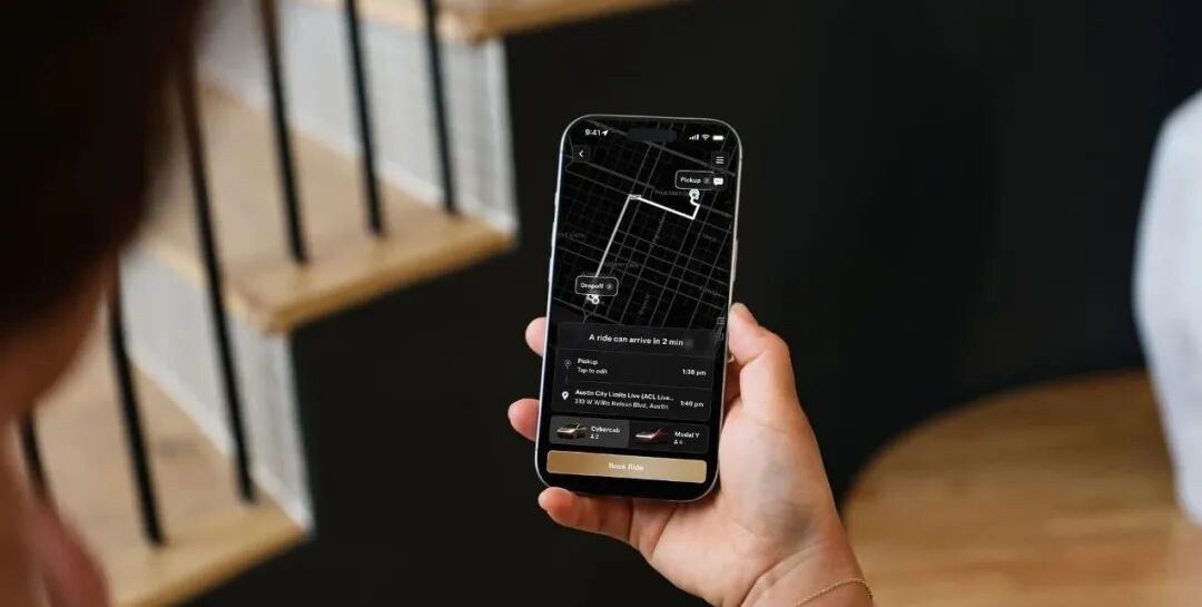 Two smartphones displaying the Robotaxi app. One shows a map and destination options and the second shows the login screen.